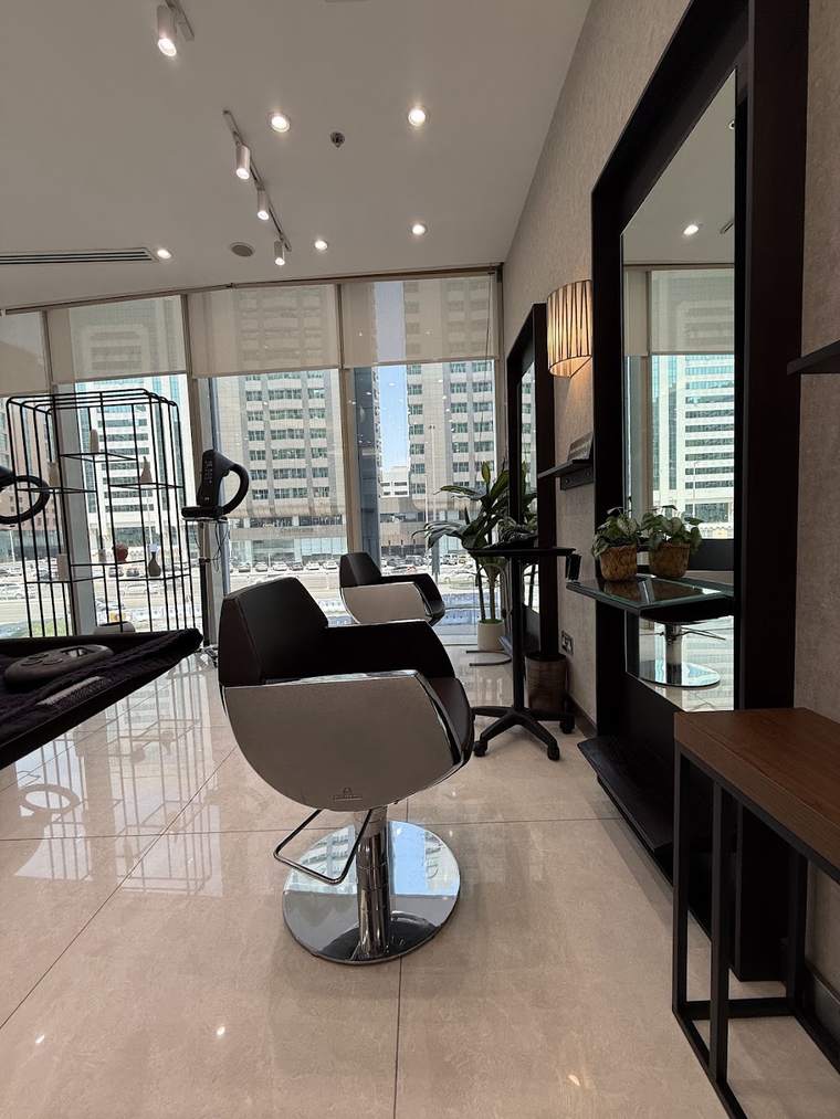 A styling chair beside the window