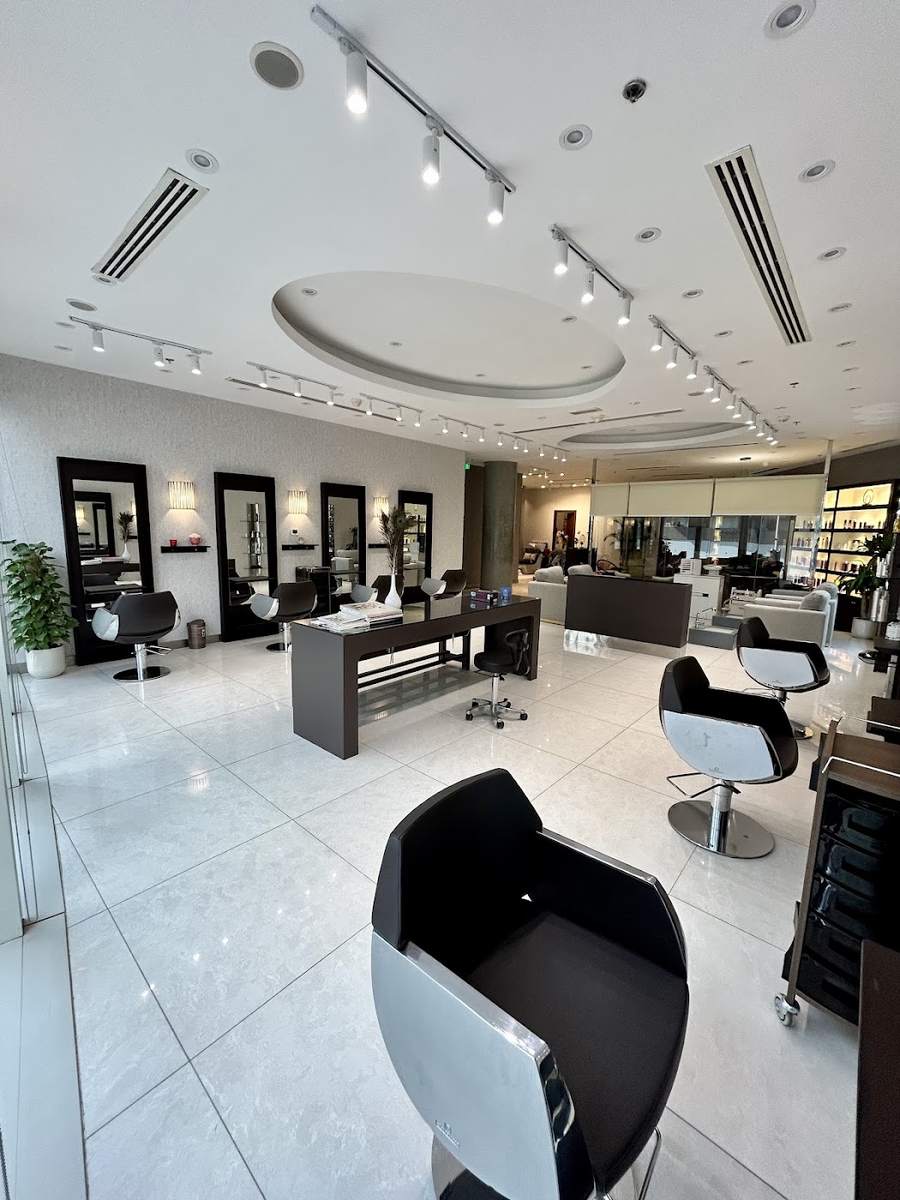 Styling stations with round mirrors and black chairs