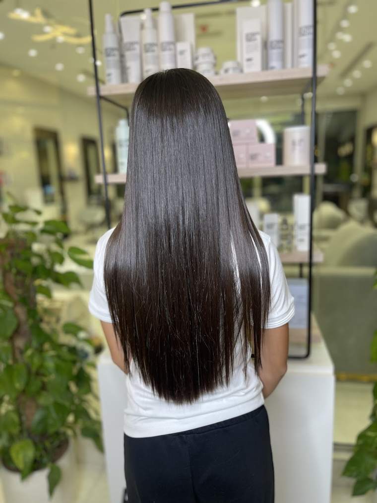 Long glossy dark hair after a blow-dry, from the salon's own photos